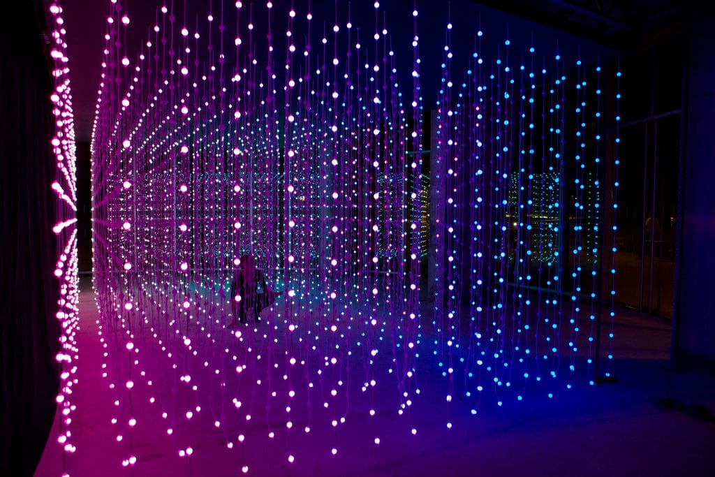 Woman walks through light installation by Squid Soup.