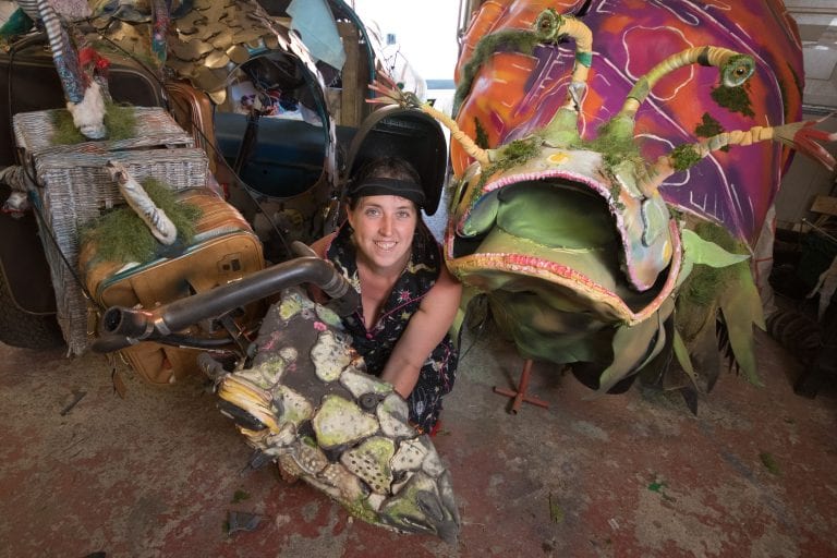 Ruby Jennings surrounded by model artworks.