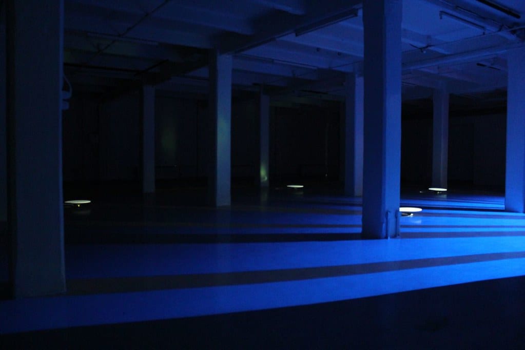 Dark room with pillars lit up in blue.