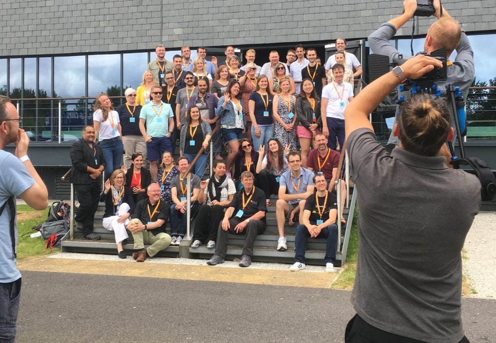 Group pose for photo at Agile On the Beach conference.