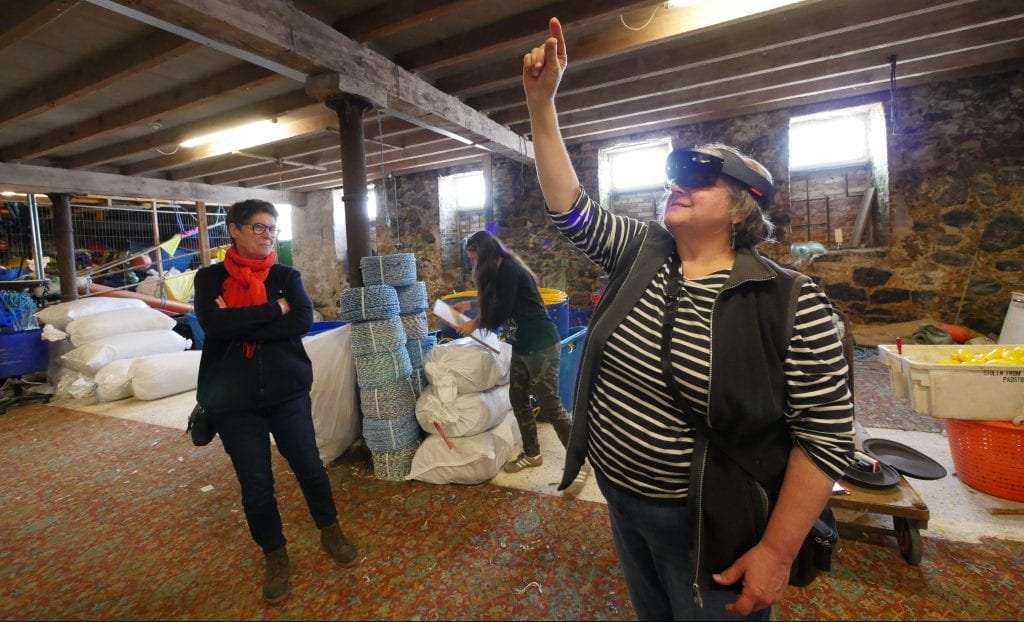 Woman wearing VR headset at The Fish Cellar at Porthmeor, St Ives.