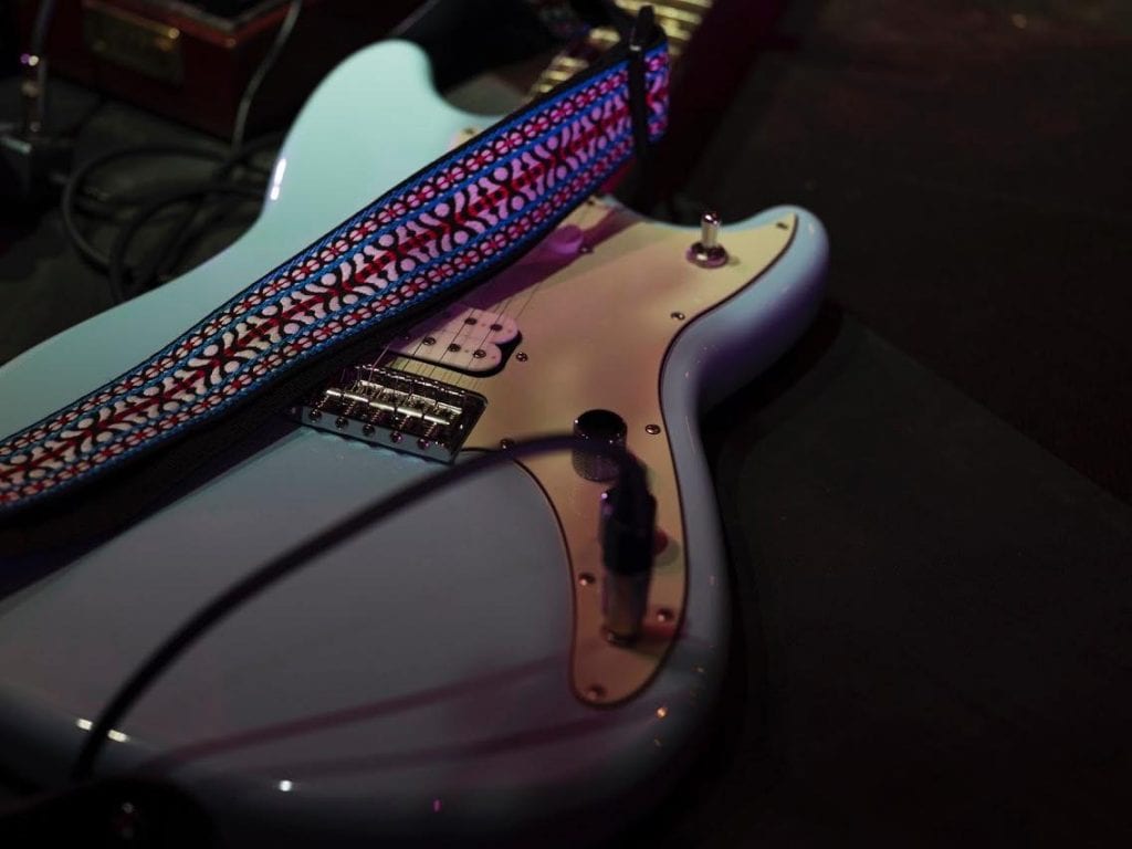 Close up of blue electric guitar.