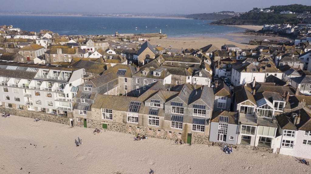 View from above of buildings with coast either side.