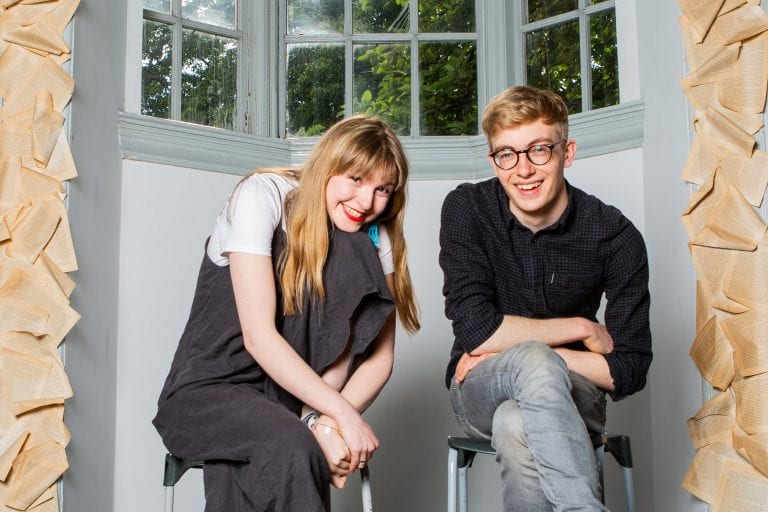 KILL THE CAT THEATRE. a blonde woman is on the left and a man with short hair and glasses is in the right