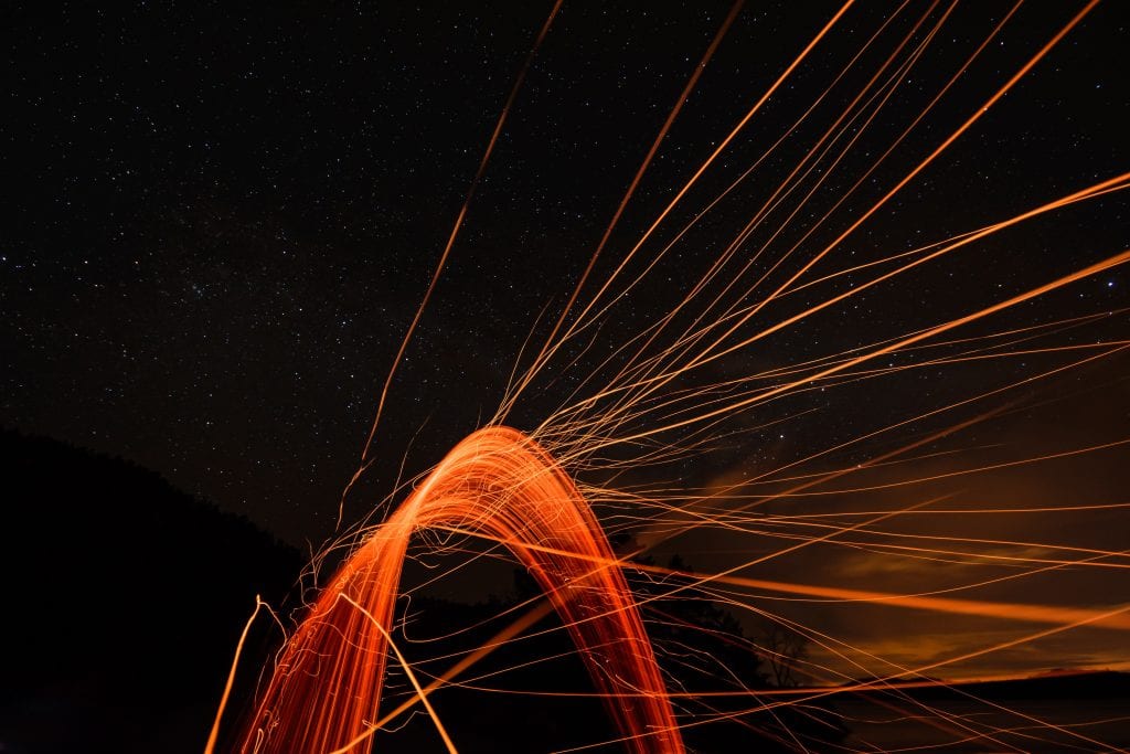 abstract image of orange lines in a curve on a dark background