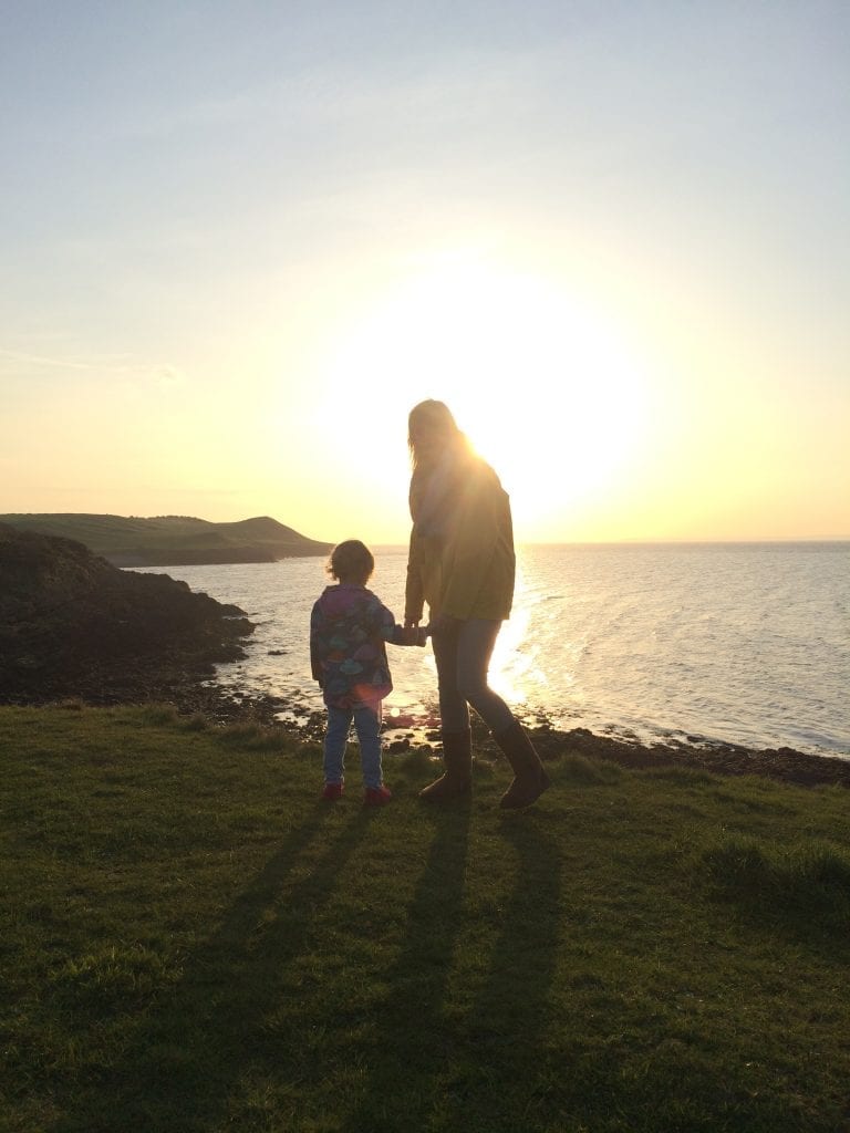 image of an adult and cild looking at the sunset